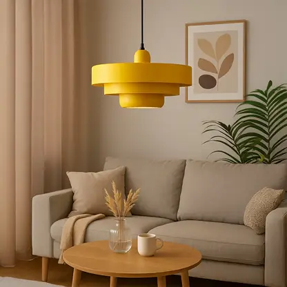Yellow metal pendant light hanging above side table in living room creating warm modern ambiance.