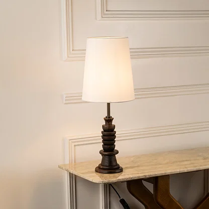 Table lamp with white fabric shade and detailed base perfect for bedroom or living room table decor styling on clean white background.