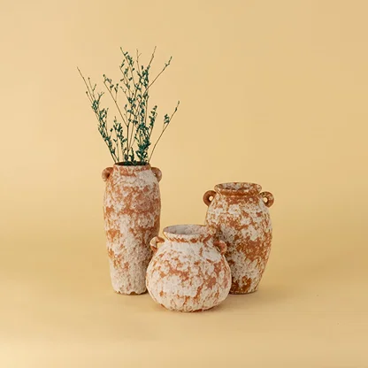 Set of rustic terracotta ceramic vases in earthy orange white finish styled together as decorative accents for home decor.