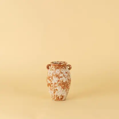 Handcrafted terracotta ceramic vase with dual handles in rustic orange white textured finish for modern home decoration.