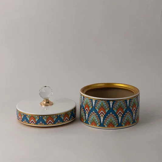 Decorative ceramic jar with artistic geometric pattern and gold accented crystal knob top for stylish home decor.