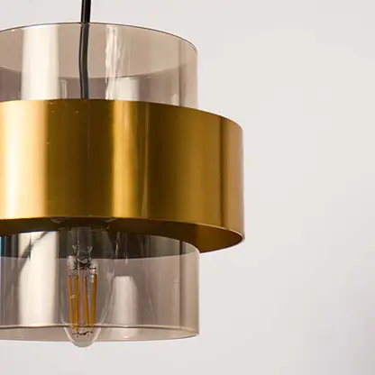 Closeup of clear glass and brass metal pendant light showcasing premium finish and craftsmanship.
