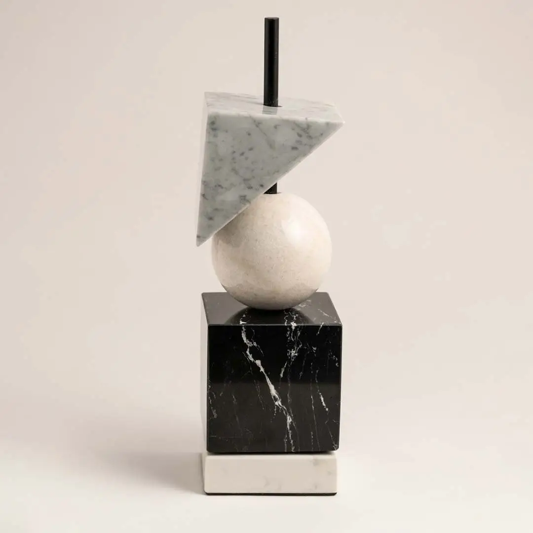Modern marble geometric decor piece with cube sphere and triangle shapes displayed on plain white background.