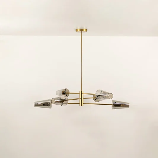 Clear glass shade chandelier with gold metal frame designed for elegant modern ceiling lighting in contemporary interiors.