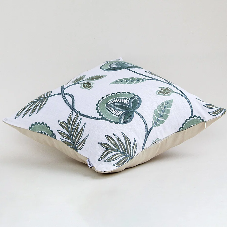Alternate side view of the floral embroidered cushion showing its smooth edges and raised embroidery details.