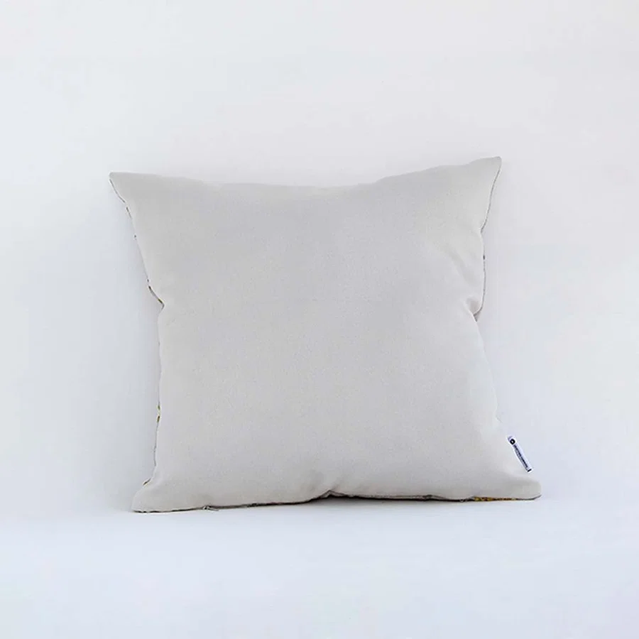 Side view of the floral embroidered cushion showcasing its filled shape and elegant stitched pattern.