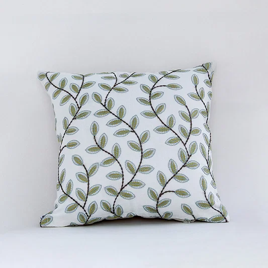 White cotton cushion cover with green botanical leaf print for sofa bedroom seating and fresh modern home decor styling.
