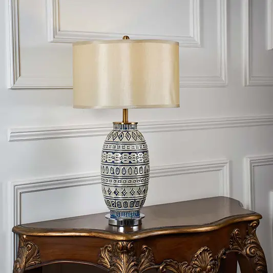 Blue and white patterned ceramic table lamp with fabric shade designed for elegant traditional decor and ambient lighting.