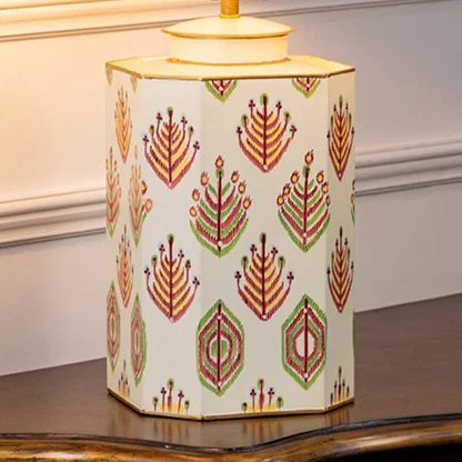 Table lamp closeup highlighting patterned ceramic base with symmetrical leaf motifs and fine handcrafted detailing.