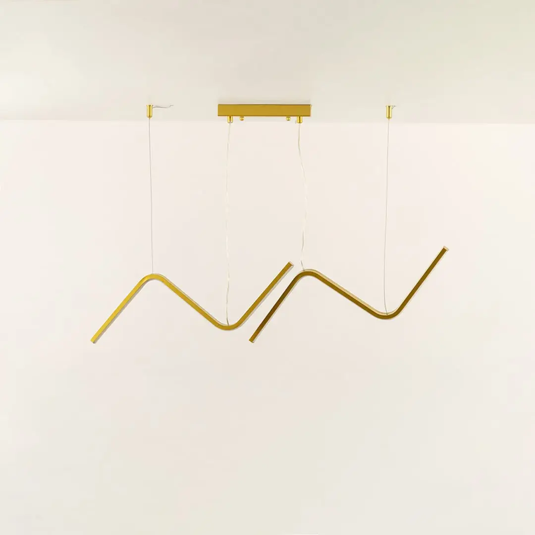 Gold wave LED chandelier featuring curved LED bars creating warm ambient illumination perfect for luxury dining rooms and high end interior lighting design.