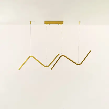 Gold wave LED chandelier featuring curved LED bars creating warm ambient illumination perfect for luxury dining rooms and high end interior lighting design.