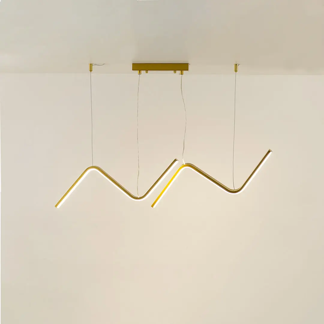 Gold metal zigzag LED pendant light with integrated illumination creating artistic modern ceiling lighting indoors.