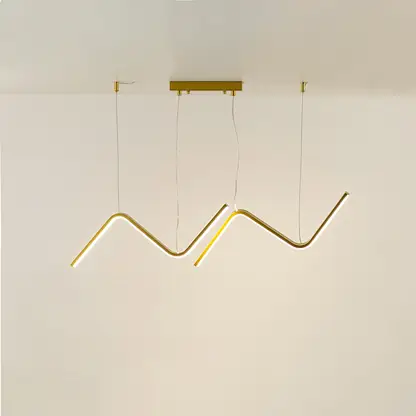 Gold metal zigzag LED pendant light with integrated illumination creating artistic modern ceiling lighting indoors.