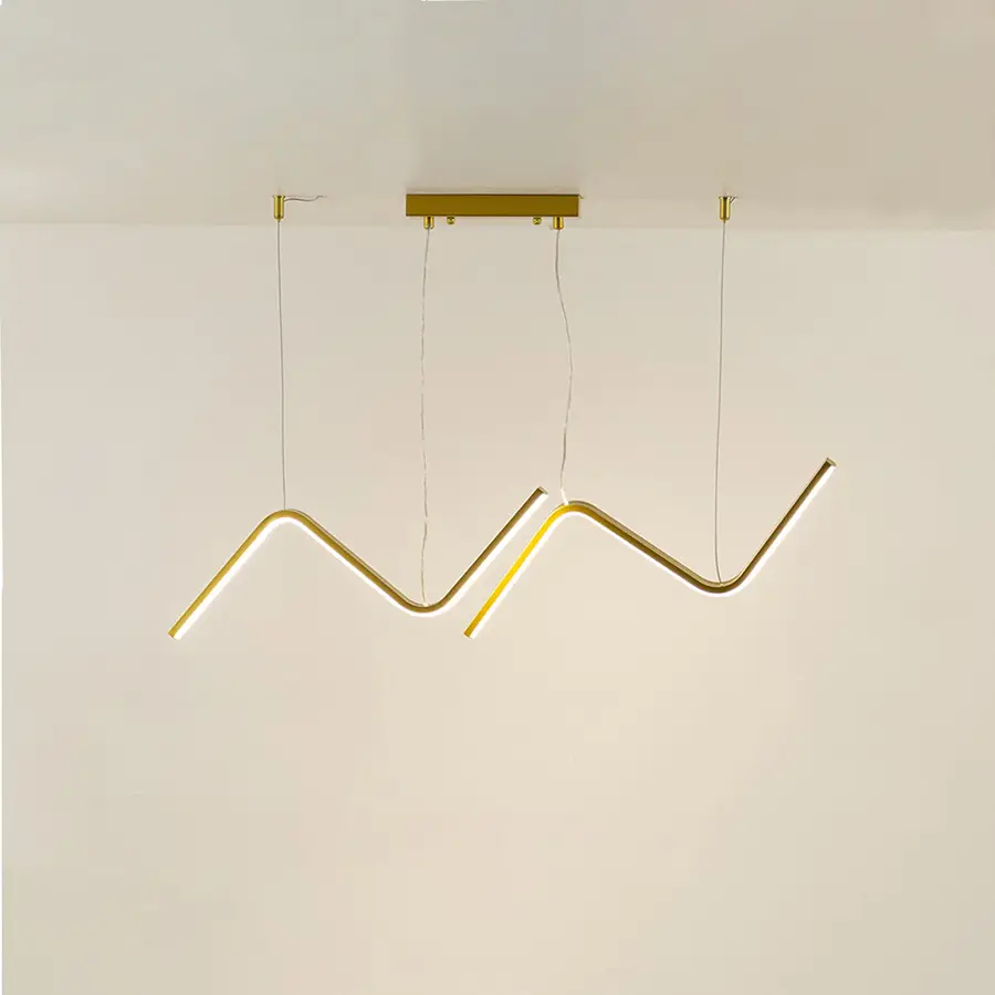 Gold metal zigzag LED pendant light with integrated illumination creating artistic modern ceiling lighting indoors.