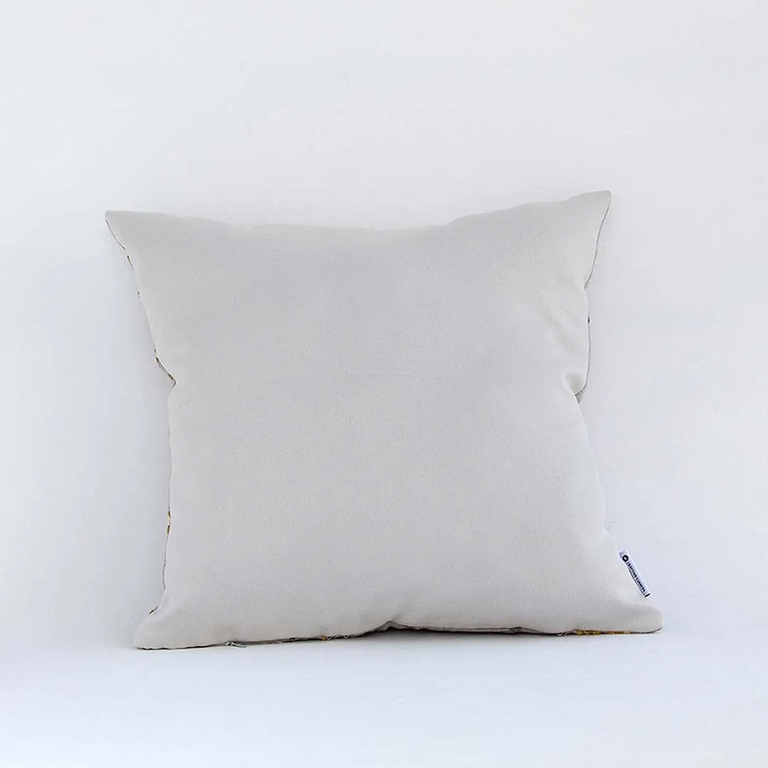 Side view of the floral cushion displaying its plush filled form and elegant embroidered pattern.