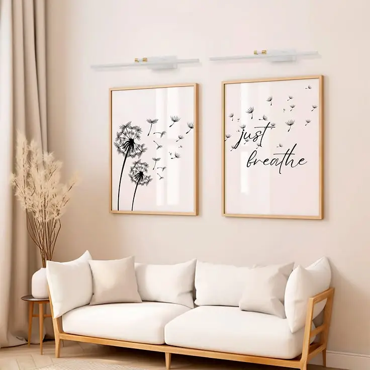 White and gold metal picture light styled on a modern interior wall adding soft focused illumination for elegant home decor.