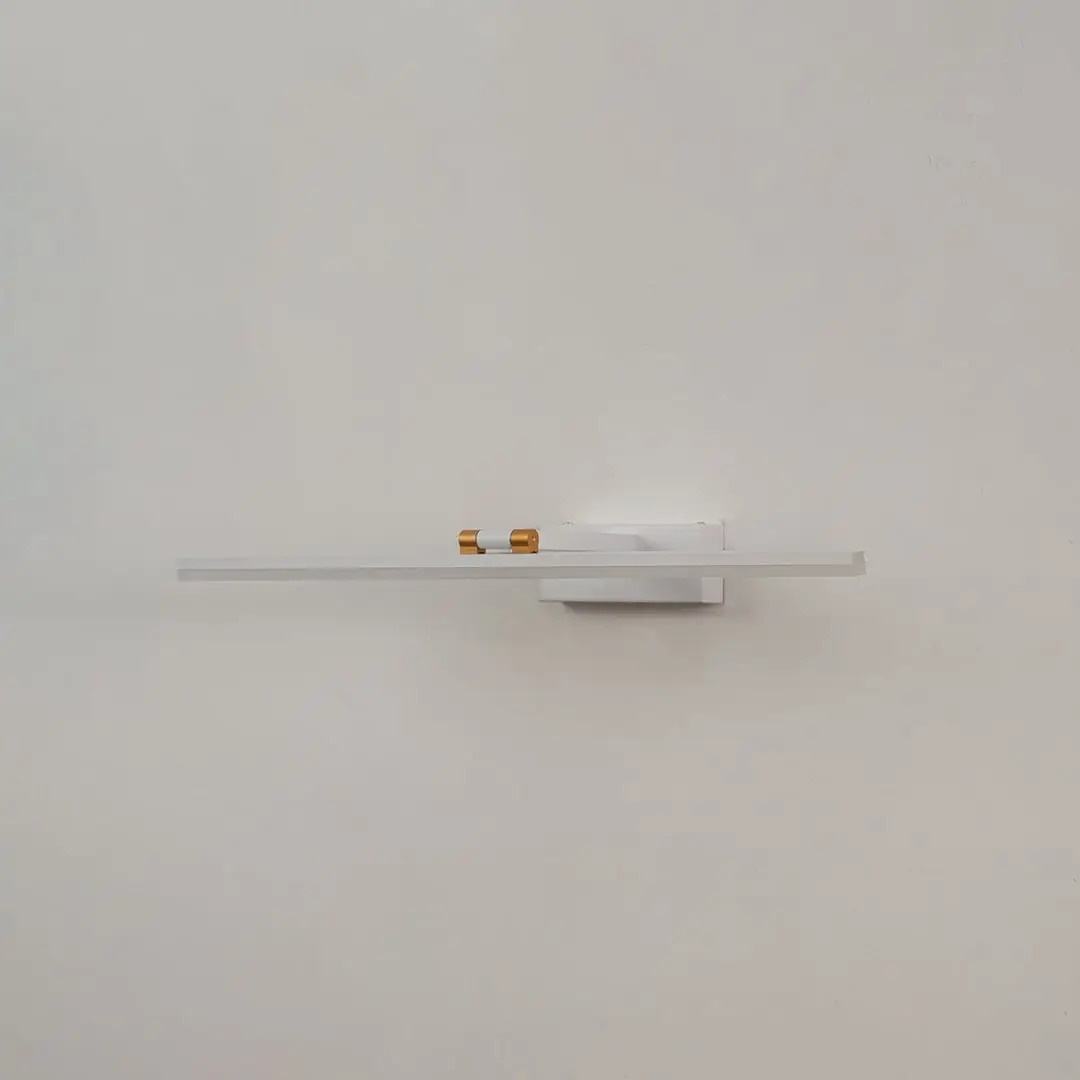 White and gold metal picture light on a white background with the light off highlighting its minimal modern design.