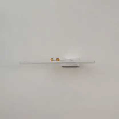 White and gold metal picture light on a white background with the light off highlighting its minimal modern design.