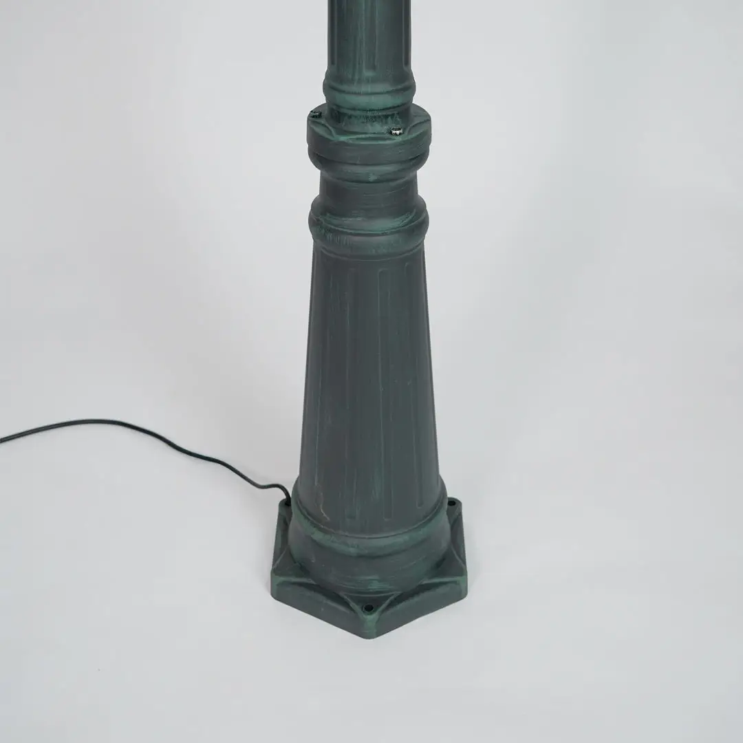 Closeup of black outdoor street lamp pole with ornate metal detailing for luxury exterior decor use.