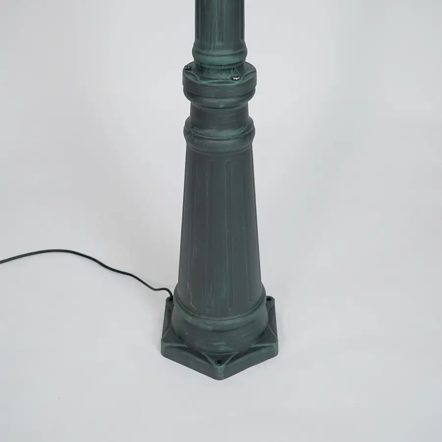 Closeup of black outdoor street lamp pole with ornate metal detailing for luxury exterior decor use.