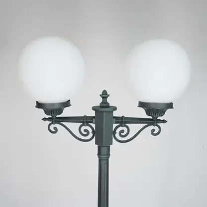 Closeup of vintage outdoor street lamp with dual frosted globe lights for elegant exterior decor styling.