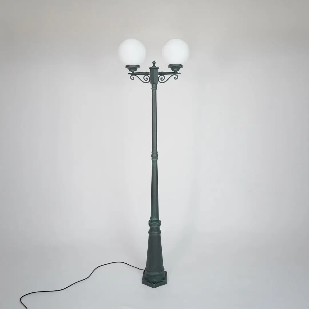 Vintage outdoor street lamp with glowing dual globe lights for elegant exterior decor styling use.