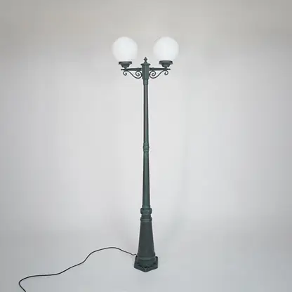 Vintage outdoor street lamp with glowing dual globe lights for elegant exterior decor styling use.