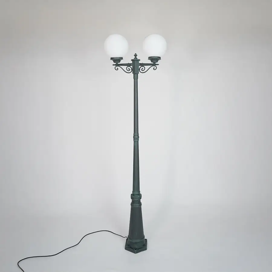 Vintage outdoor street lamp with glowing dual globe lights for elegant exterior decor styling use.