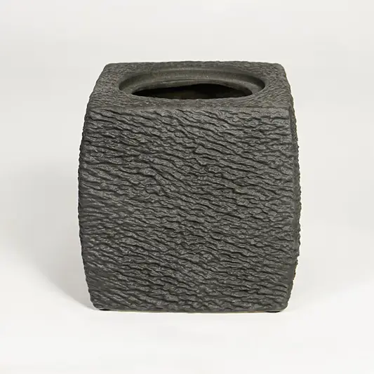 Dark grey decorative ceramic planter on white background modern home decor accent piece for table floor console styling.