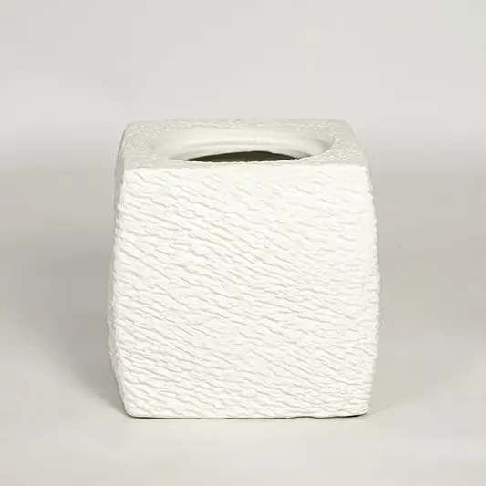 White decorative textured ceramic planter on white background modern home decor accent piece for table floor console styling.