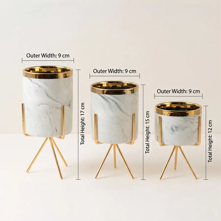 Three marble planters with gold metal rims and tripod stands, shown in different sizes with dimension labels for outer width and total height on a light neutral background.