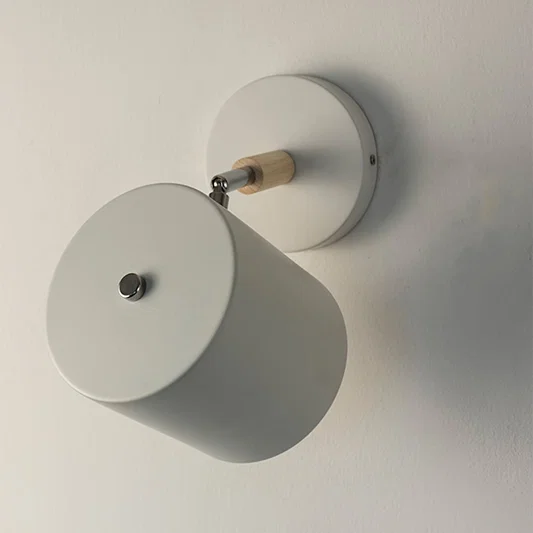 Modern white metal spotlight wall light with minimalist matte finish for stylish interior lighting decor.