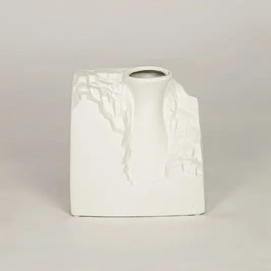 White ceramic decorative vase with sculpted artistic texture for modern tabletop shelf and console decor placement.