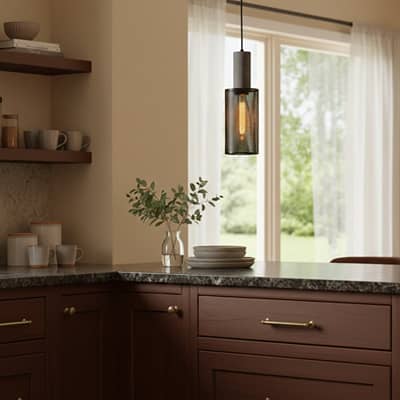 Twin gold metal pendant lights enhancing kitchen decor with minimalist elegance and soft illumination.