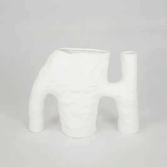 White textured ceramic vase for modern console table placement and artistic indoor home decor styling statement piece.