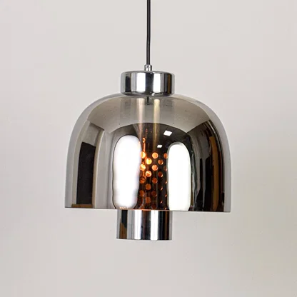 Smoke glass and chrome metal pendant light designed for modern dining room and home decor spaces.