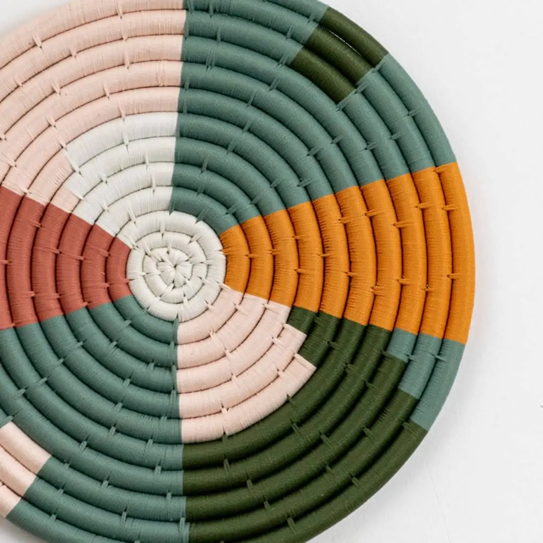 Closeup of woven multicolor seagrass wall basket with geometric pattern for stylish boho home wall décor display.