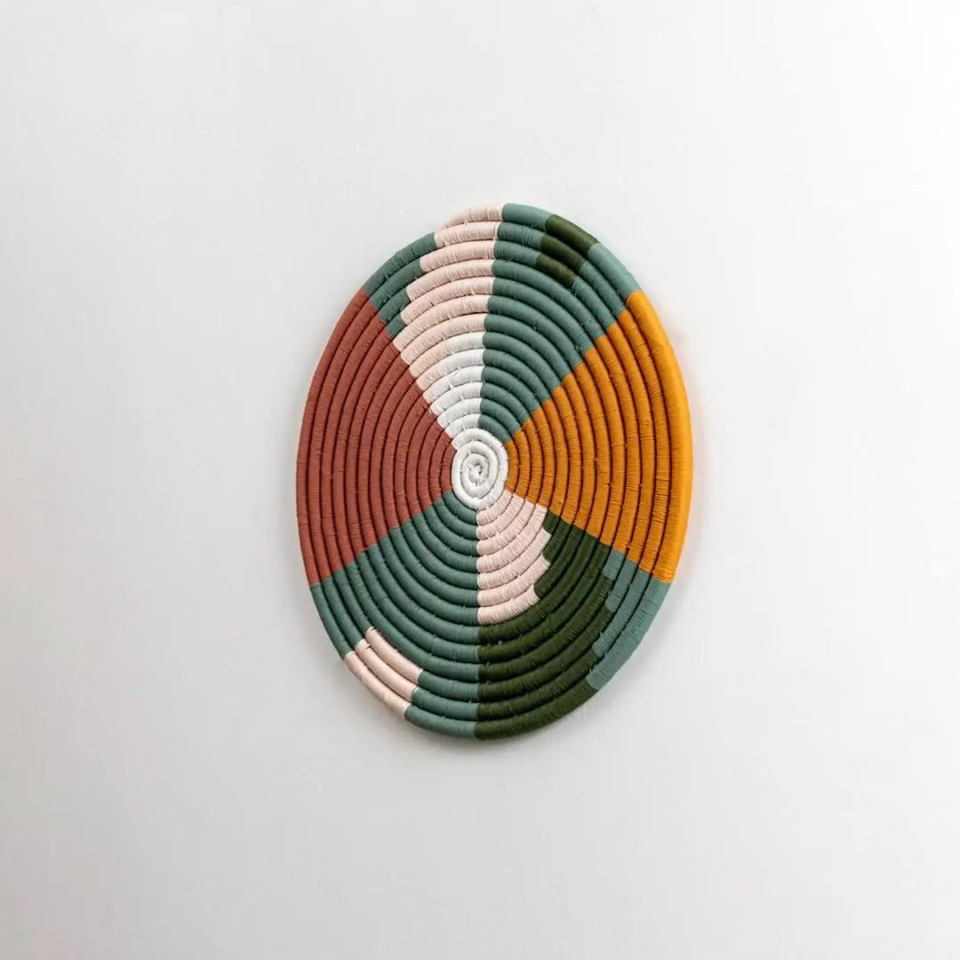 Handcrafted multicolor seagrass wall basket for living room hallway and boho décor on white background image.