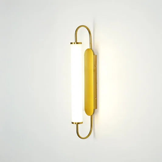 Gold metal wall light on white background with frosted glass shade for elegant minimalist interior decor.