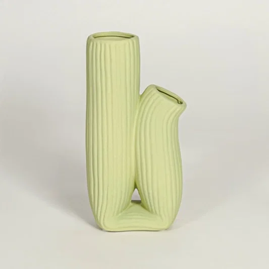Modern light green ceramic dual opening vase with ribbed body ideal for console styling and home decor display.