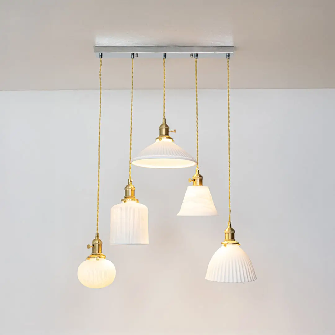 White glass and gold metal pendant lights showcasing refined designs for stylish home decor spaces.