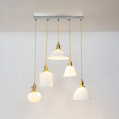 White glass and gold metal pendant lights showcasing refined designs for stylish home decor spaces.