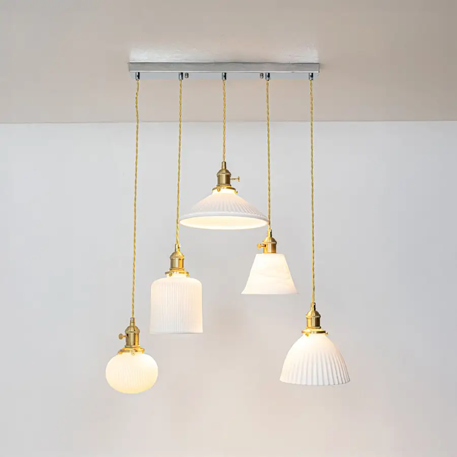 White glass and gold metal pendant lights showcasing refined designs for stylish home decor spaces.