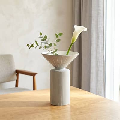 White ceramic flower vase placed on wooden table modern decorative vase for living room console home decor styling.
