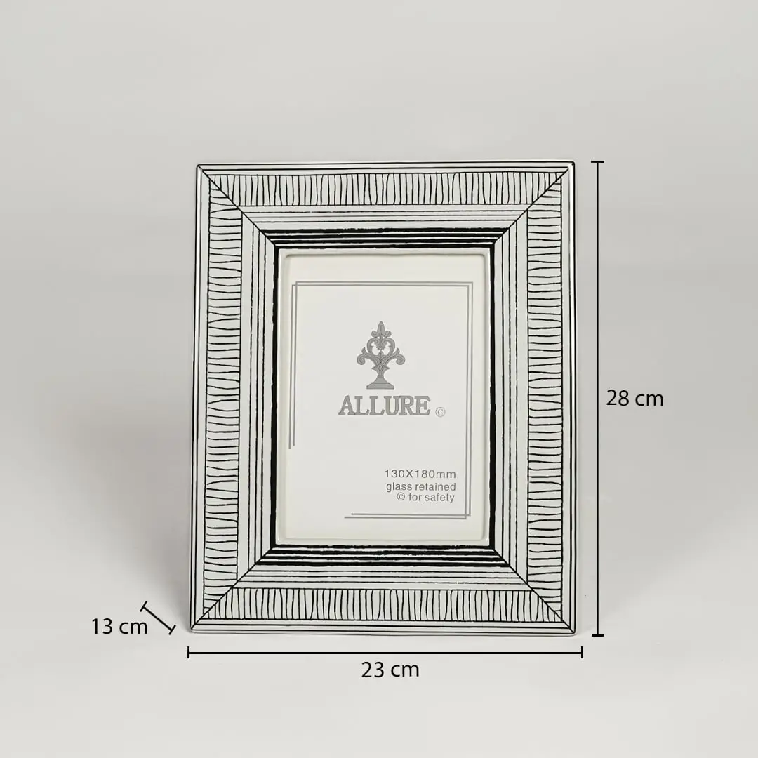 Silver metal photo frame measuring 28 cm height 23 cm width and 13 cm depth perfect for tabletop display decor.