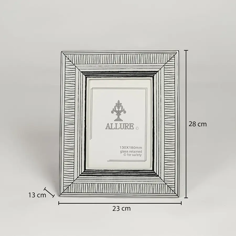 Silver metal photo frame measuring 28 cm height 23 cm width and 13 cm depth perfect for tabletop display decor.