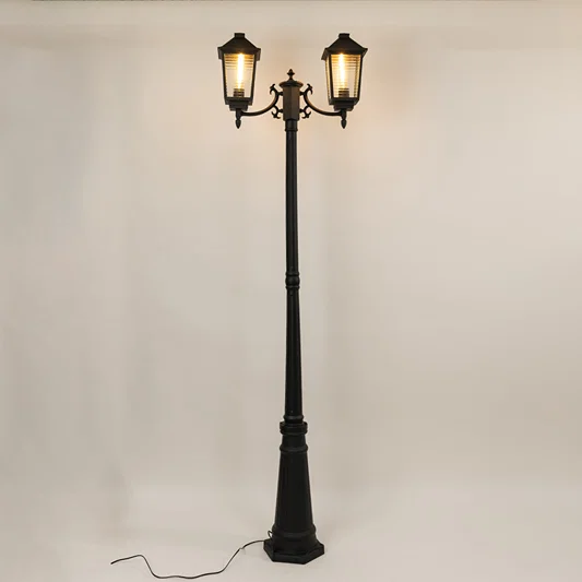 Vintage outdoor street lamp with dual glowing lanterns for elegant exterior decor styling use.
