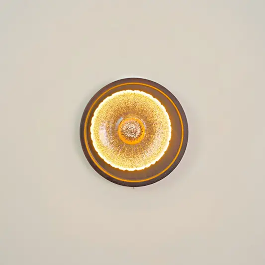 Celestial Fluted Art Wall Light illuminated on white background.