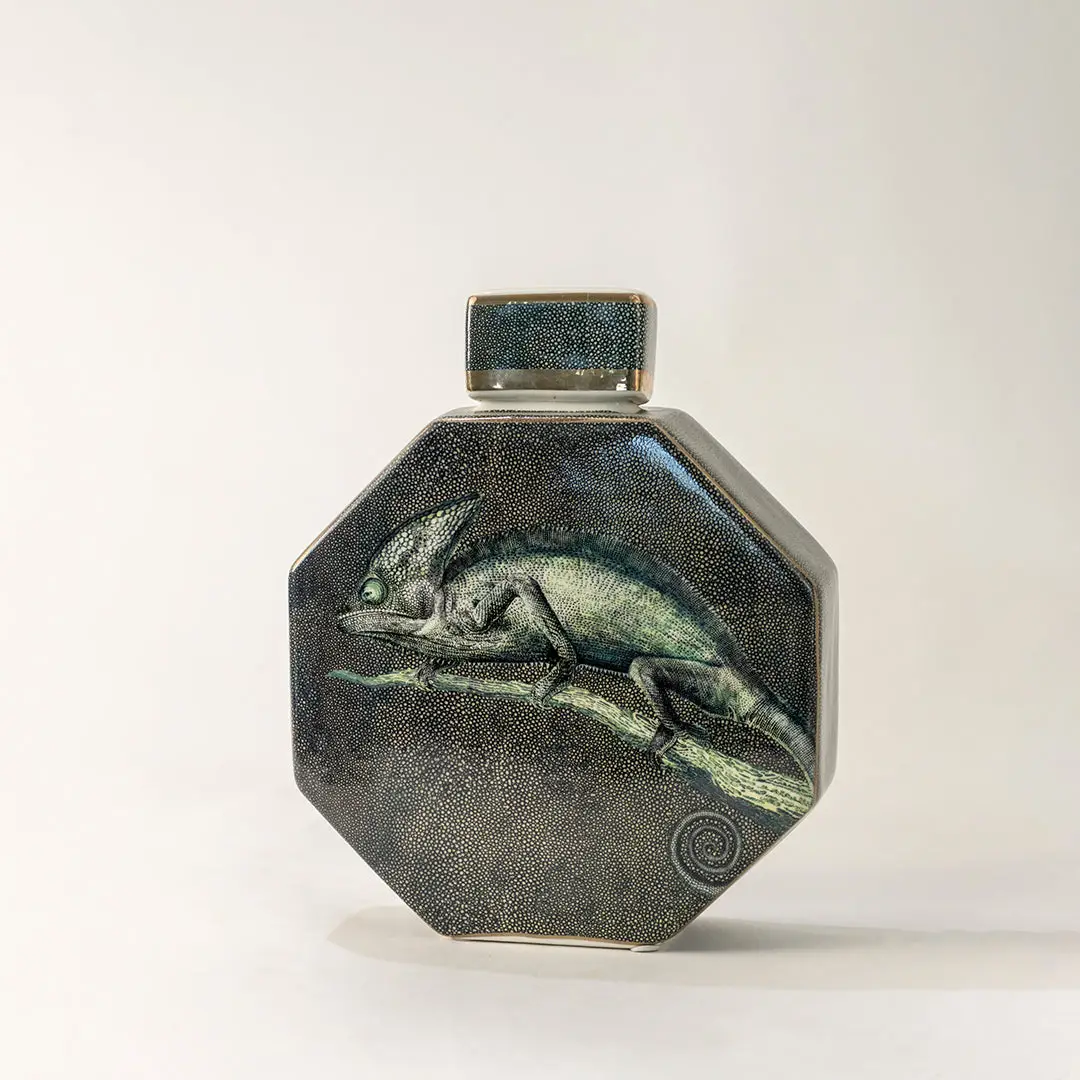 Green ceramic decorative jar with textured glaze and geometric form for elegant tabletop styling and home decor.