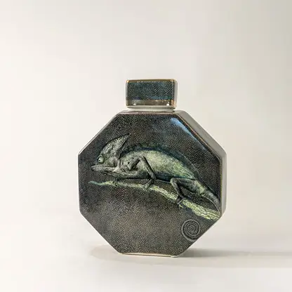 Green ceramic decorative jar with textured glaze and geometric form for elegant tabletop styling and home decor.